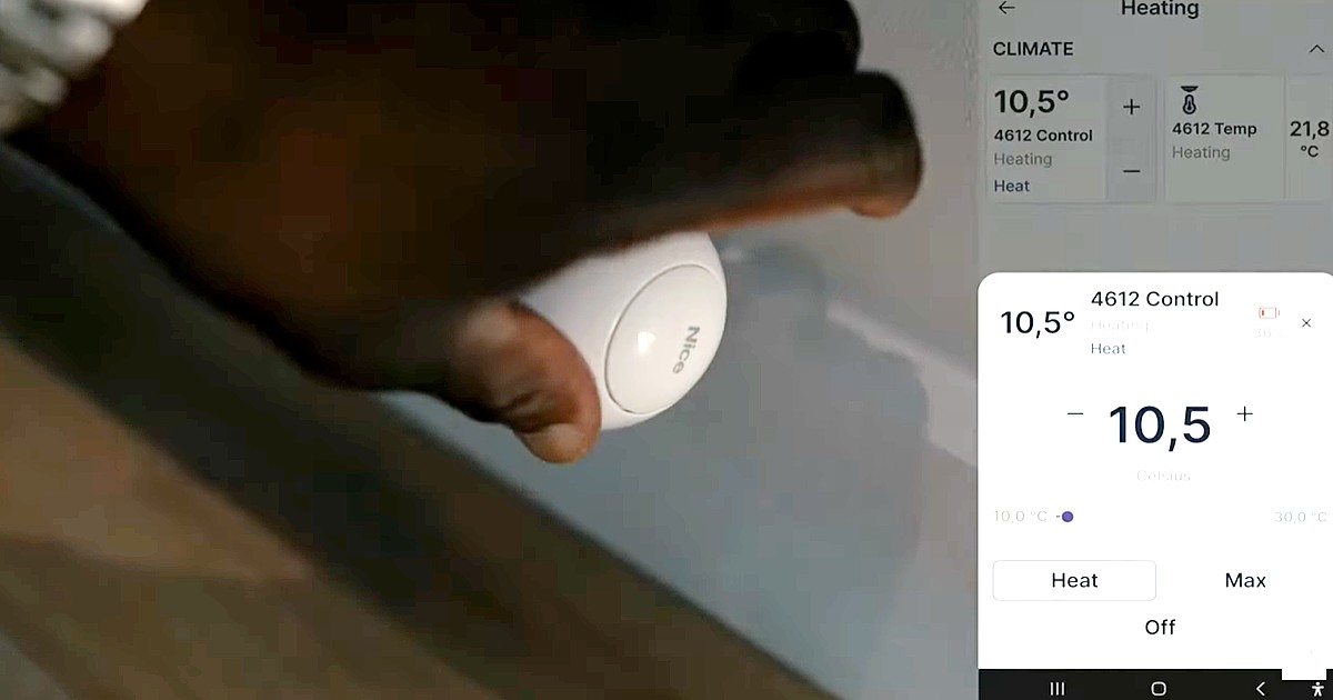 A hand reaches for Nice temperature and light control device inside Enclave: Croydon.